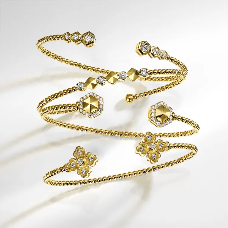 Elegant gold and diamond bracelets with geometric designs.