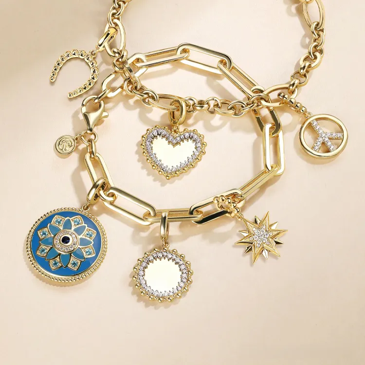 Gold charm bracelets with heart, star, and peace symbols.