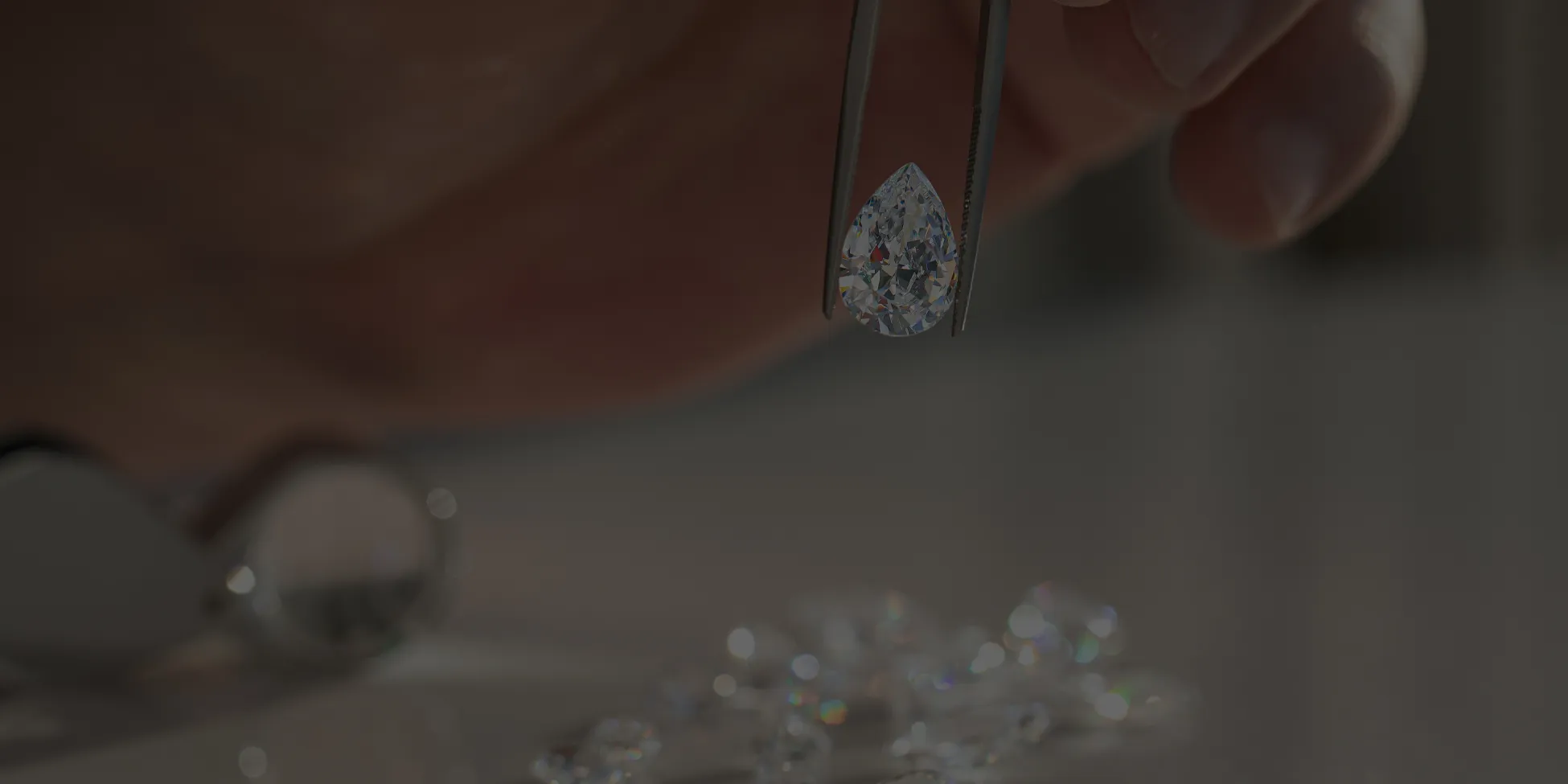 Diamond held by tweezers for consultation.