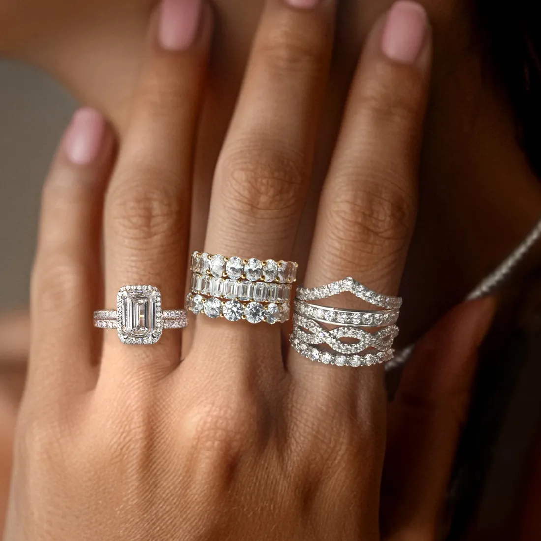 Fashion rings with diamonds on fingers.