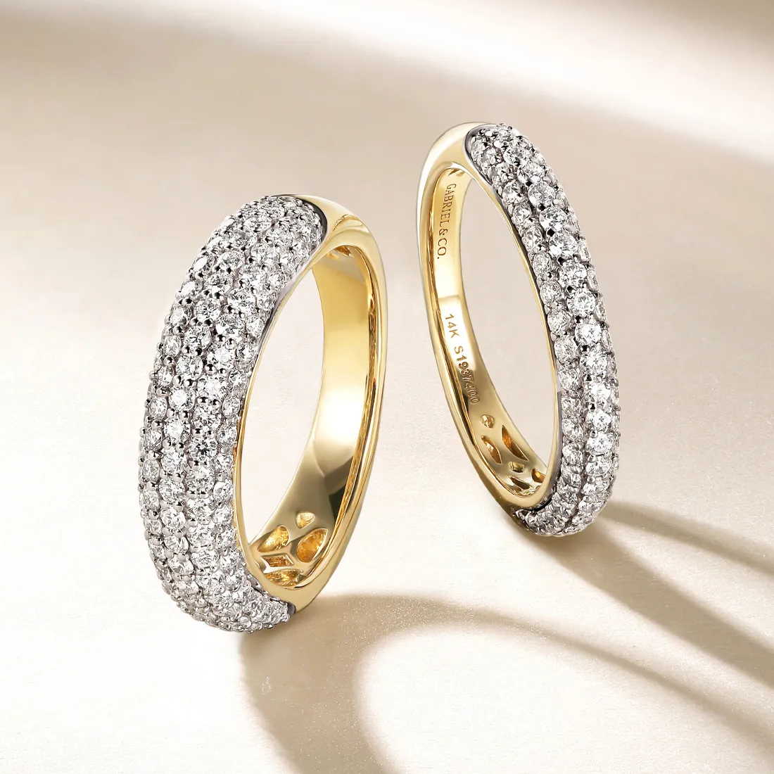 Elegant gold and diamond women's bands displayed on a soft background.