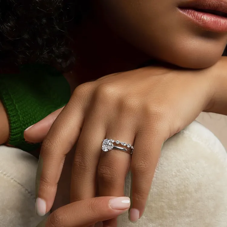 Close-up of a hand with a diamond engagement ring.