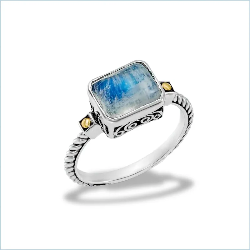 Sterling silver ring with a blue stone and gold accents, available at Branham's Jewelry.