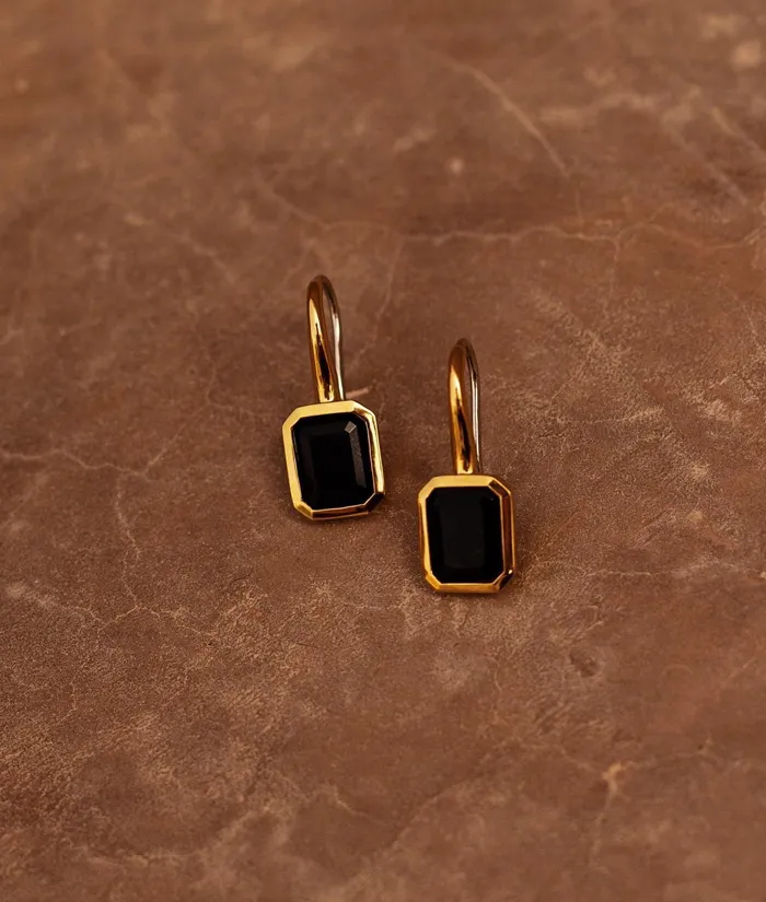 Elegant gold earrings featuring black octagonal stones, perfect for any occasion. Shop now at Bryan Jewelry in Prattville.