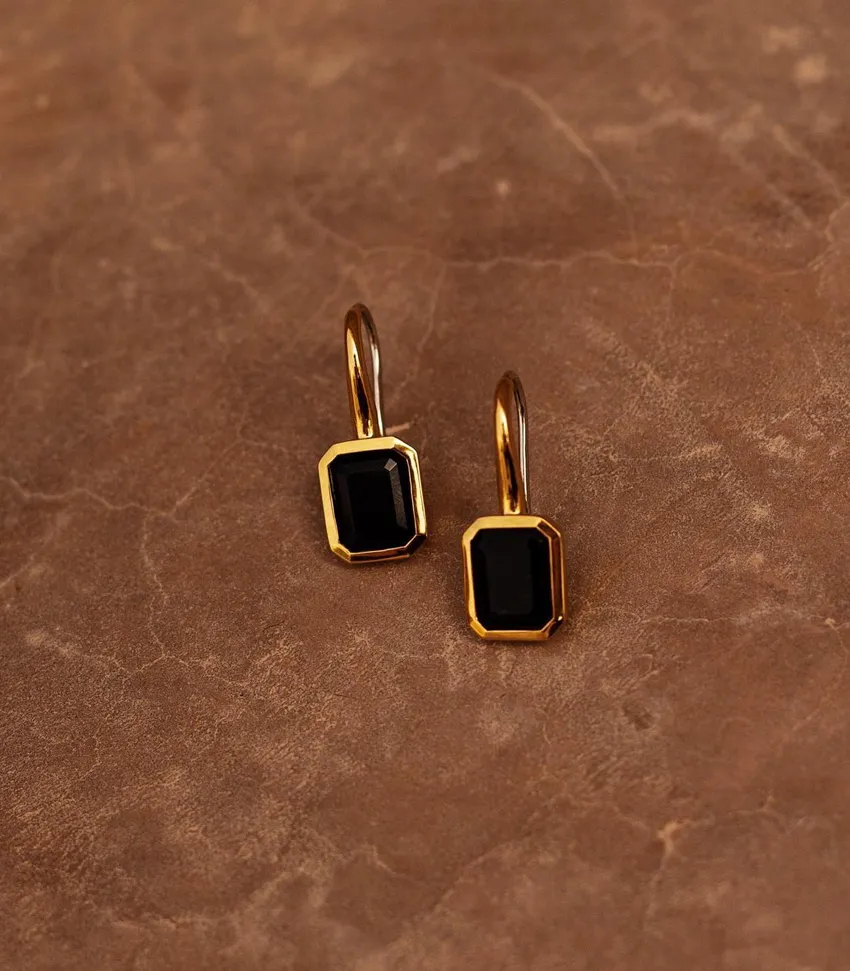 Elegant gold earrings featuring black octagonal stones, perfect for any occasion. Shop now at Bryan Jewelry in Prattville.