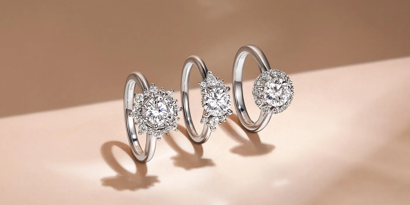 Three elegant diamond engagement rings displayed on a soft background. Visit Bryan Jewelry in Prattville for more.