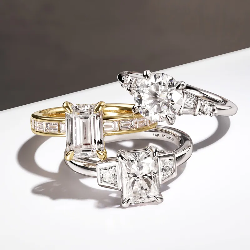 Three elegant diamond engagement rings featuring different styles and settings, showcasing luxury and craftsmanship.