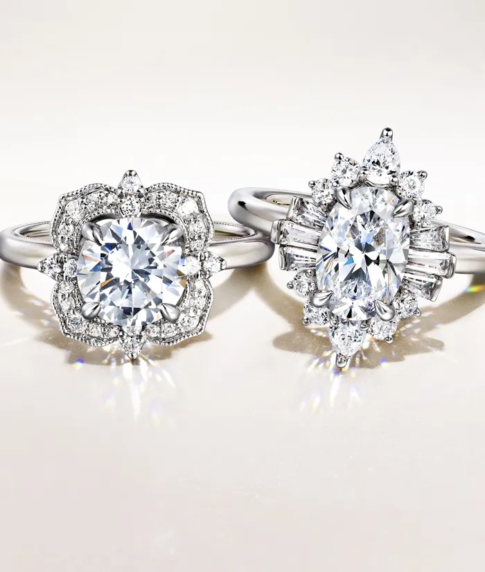 Two elegant diamond engagement rings on a light background. Click to learn more about choosing the right setting at Bryan Jewelr