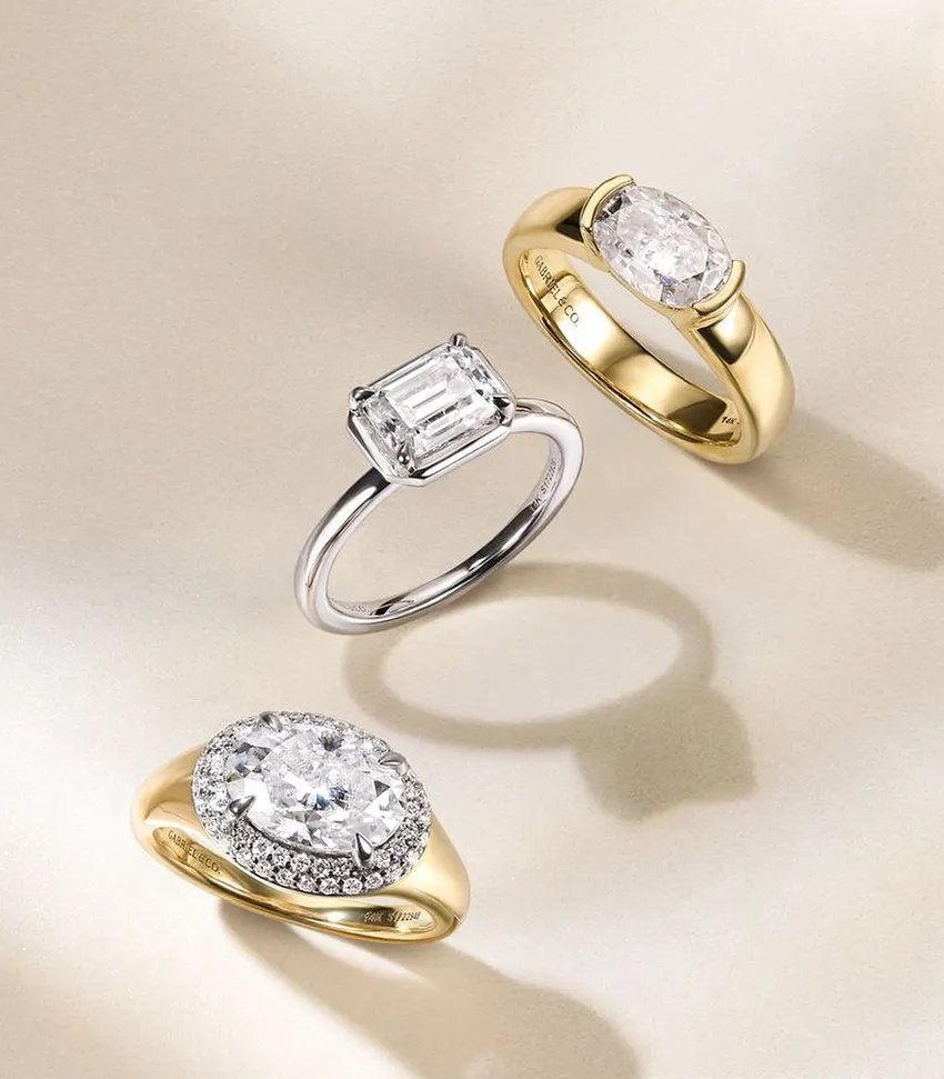 Three elegant diamond rings featuring different styles: oval, emerald cut, and halo design, displayed on a soft background.