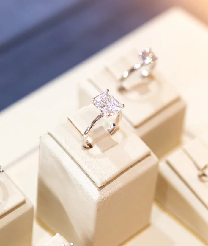 Elegant diamond engagement ring displayed on a soft pedestal at Bryan Jewelry in Prattville.