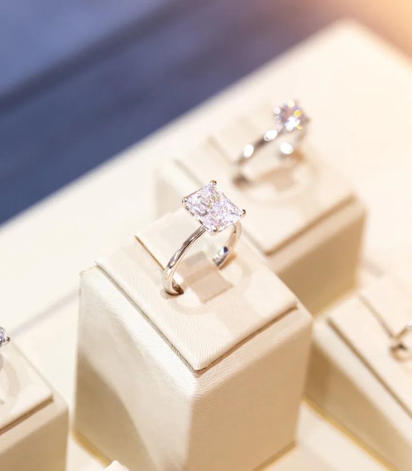 Elegant diamond engagement ring displayed on a soft pedestal at Bryan Jewelry in Prattville.