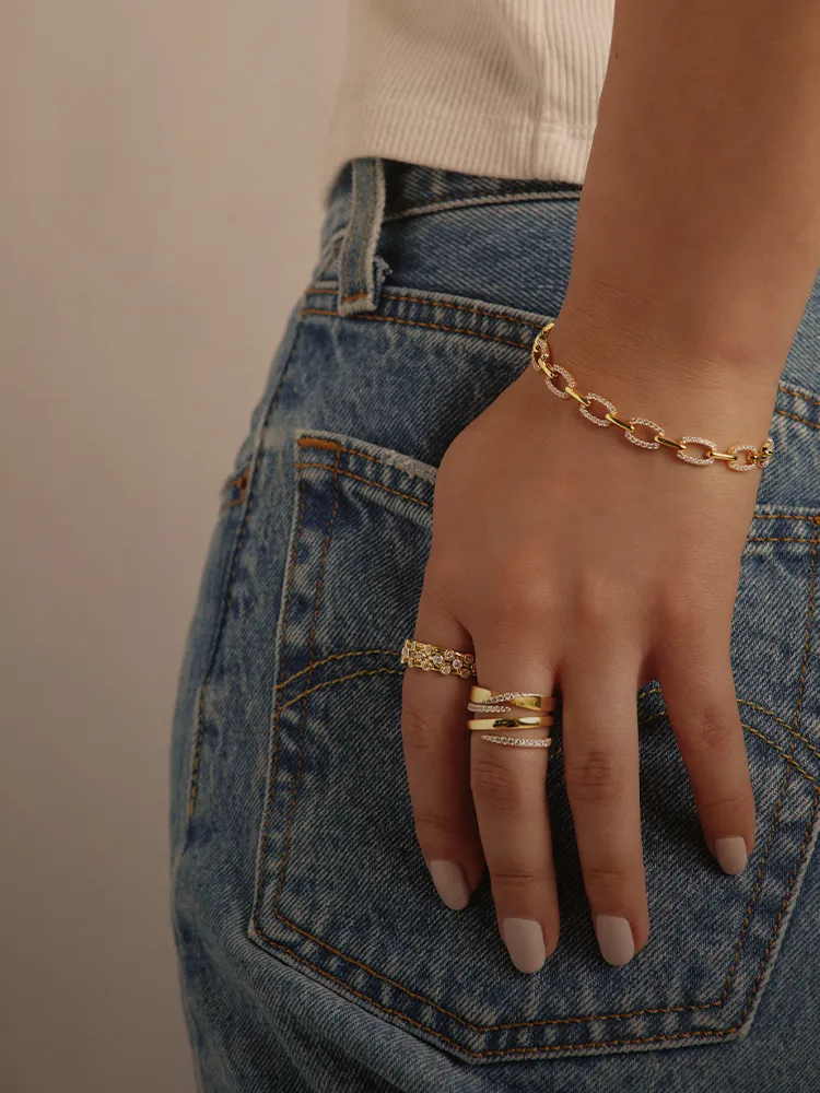 Fashion rings displayed on a hand, featuring gold and silver designs. Shop now at Bryan Jewelry in Prattville.