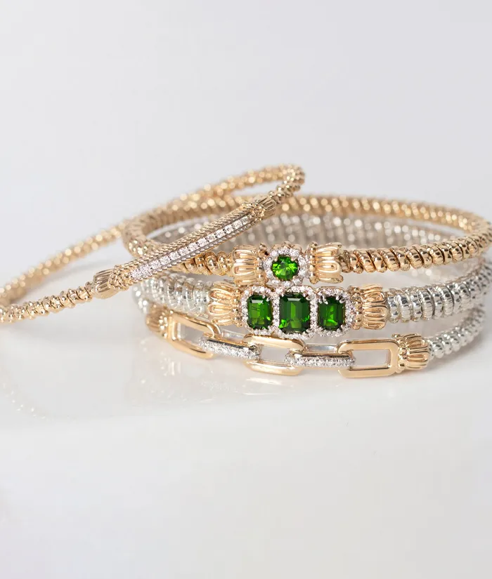 Three elegant bracelets featuring gold and silver designs with green gemstones, promoting birthstone jewelry.