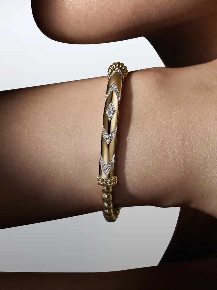 Gold and diamond bracelet on a model's wrist, showcasing elegance. Shop bracelets at Bryan Jewelry, Prattville.