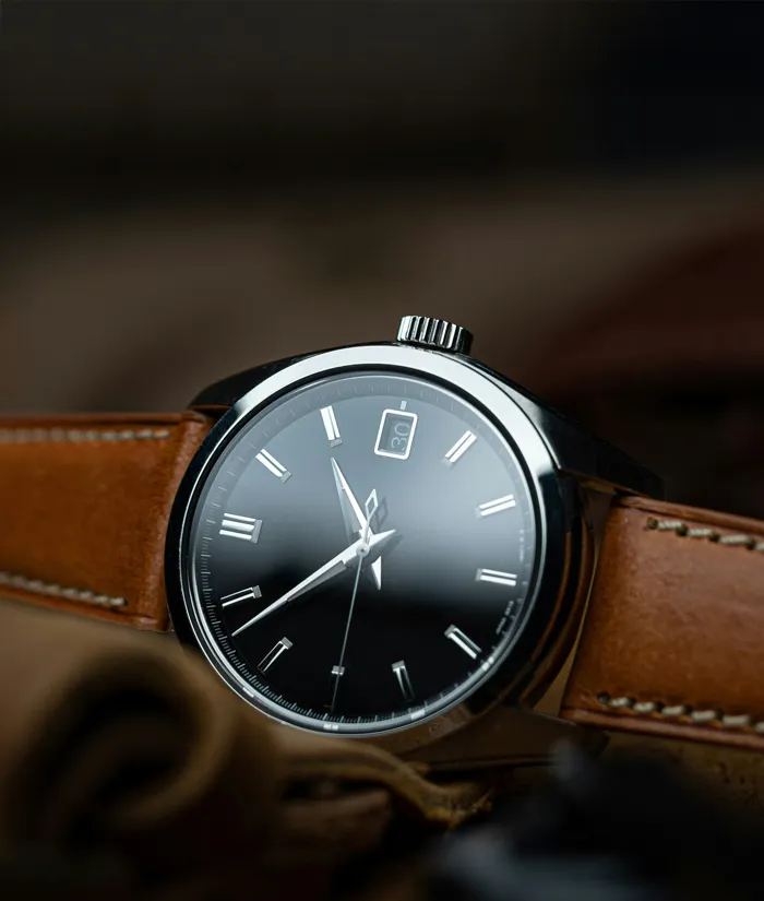 Elegant black dial watch with silver accents and brown leather strap, featured in Bryan Jewelry's pre-owned luxury collection. S