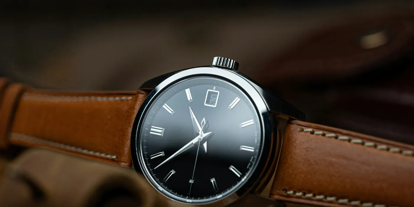 Elegant black dial watch with silver accents and brown leather strap, featured in Bryan Jewelry's pre-owned luxury collection. S
