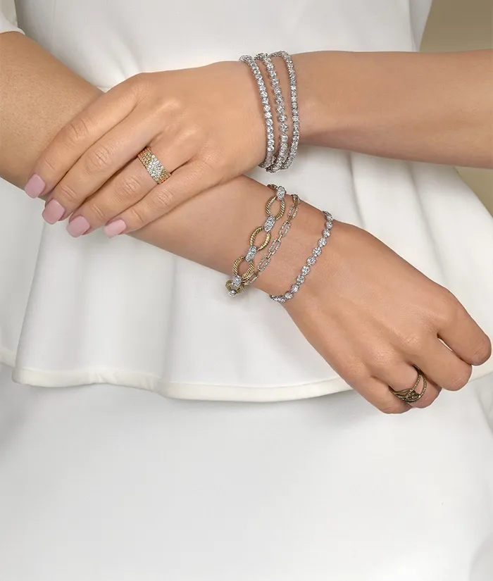 Three elegant bracelets featuring gold and silver designs with green gemstones, promoting birthstone jewelry.