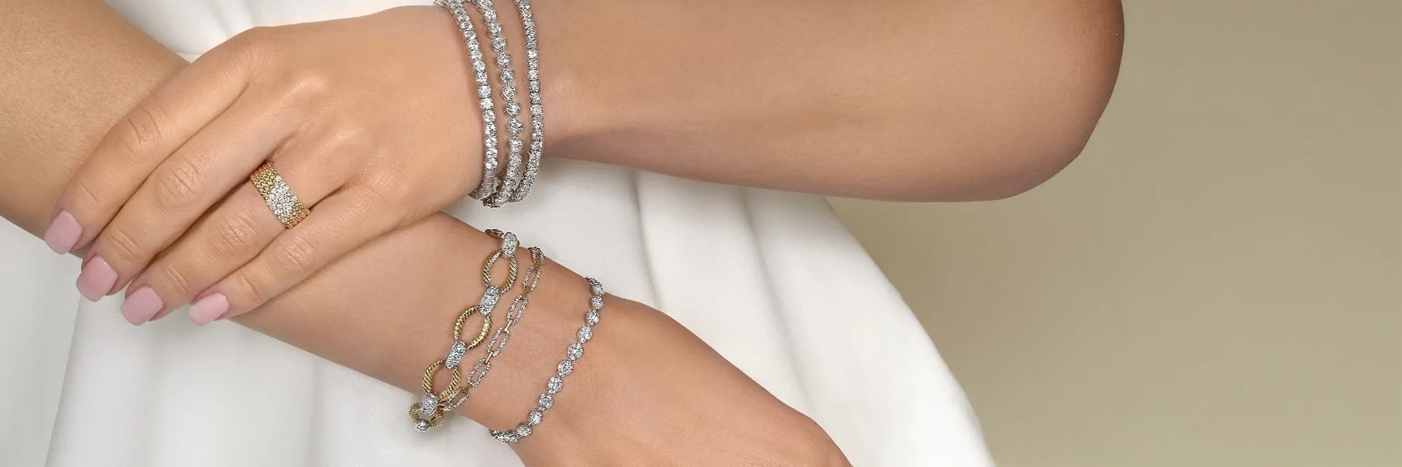Three elegant bracelets featuring gold and silver designs with green gemstones, promoting birthstone jewelry.