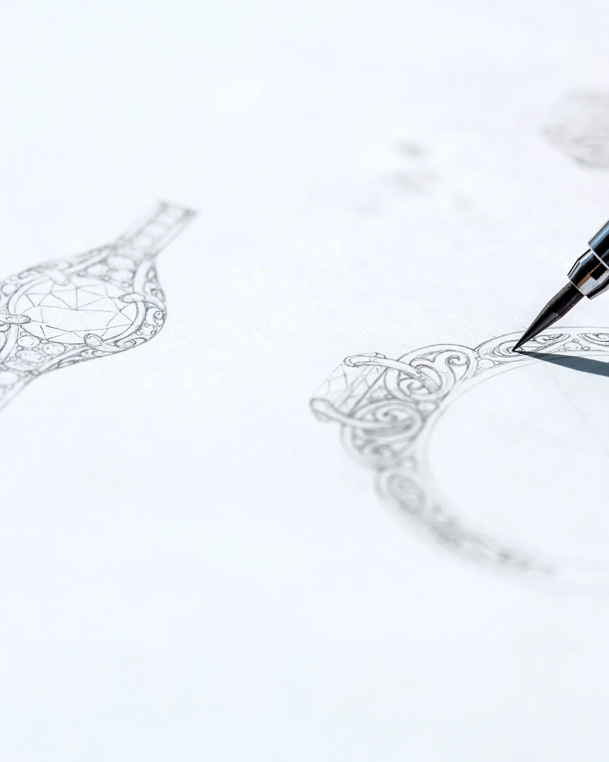 Sketch of intricate ring designs being drawn with a pen. Click to start a project.