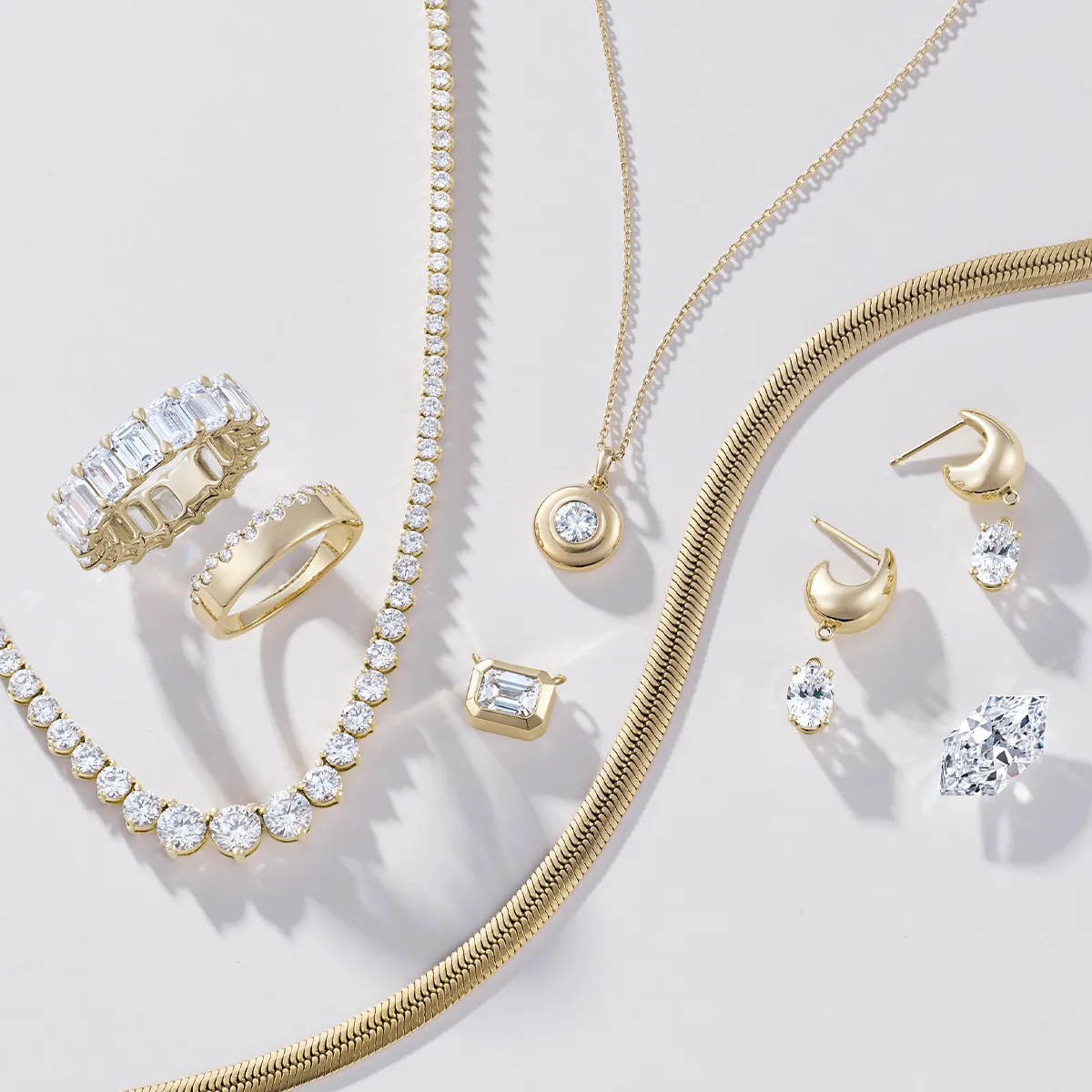 A collection of gold and diamond jewelry, including necklaces, rings, and earrings, displayed on a light background.
