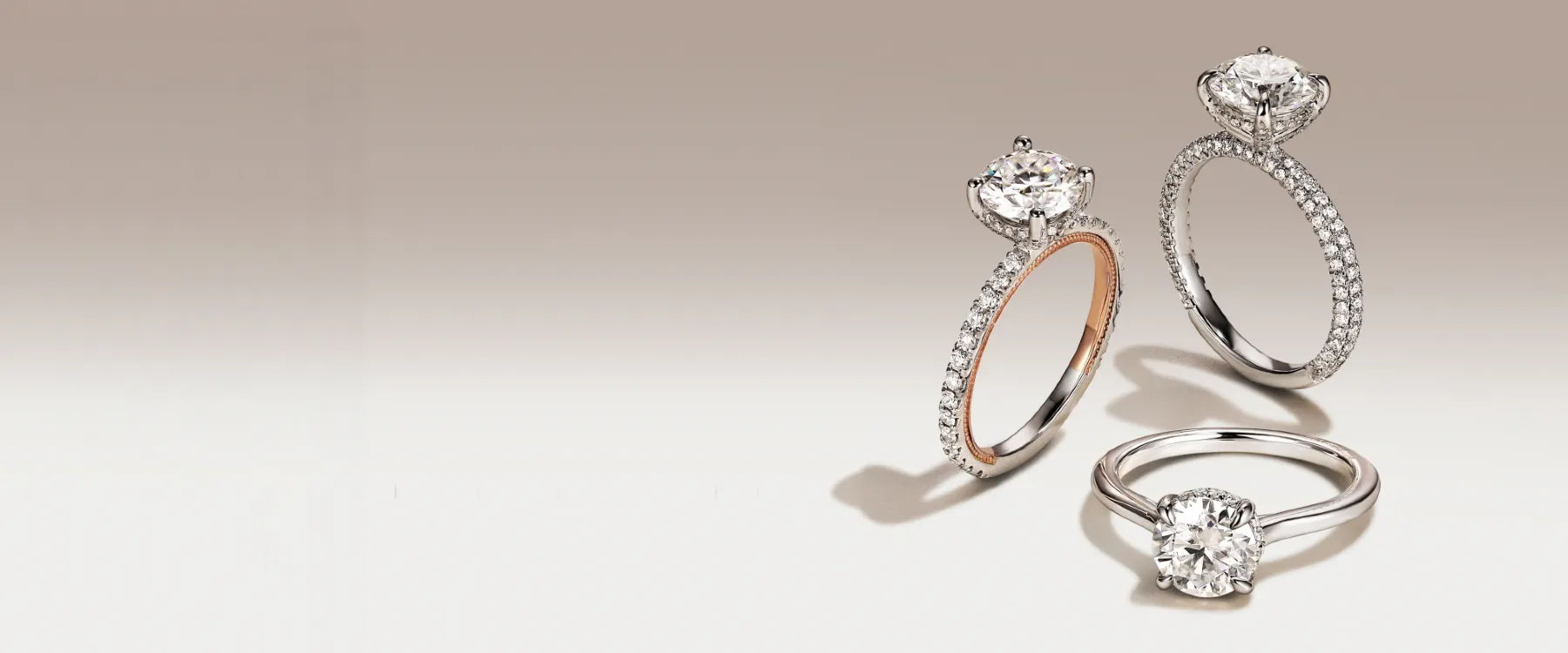 Three elegant diamond engagement rings with intricate band designs on a gradient background. Shop Now.