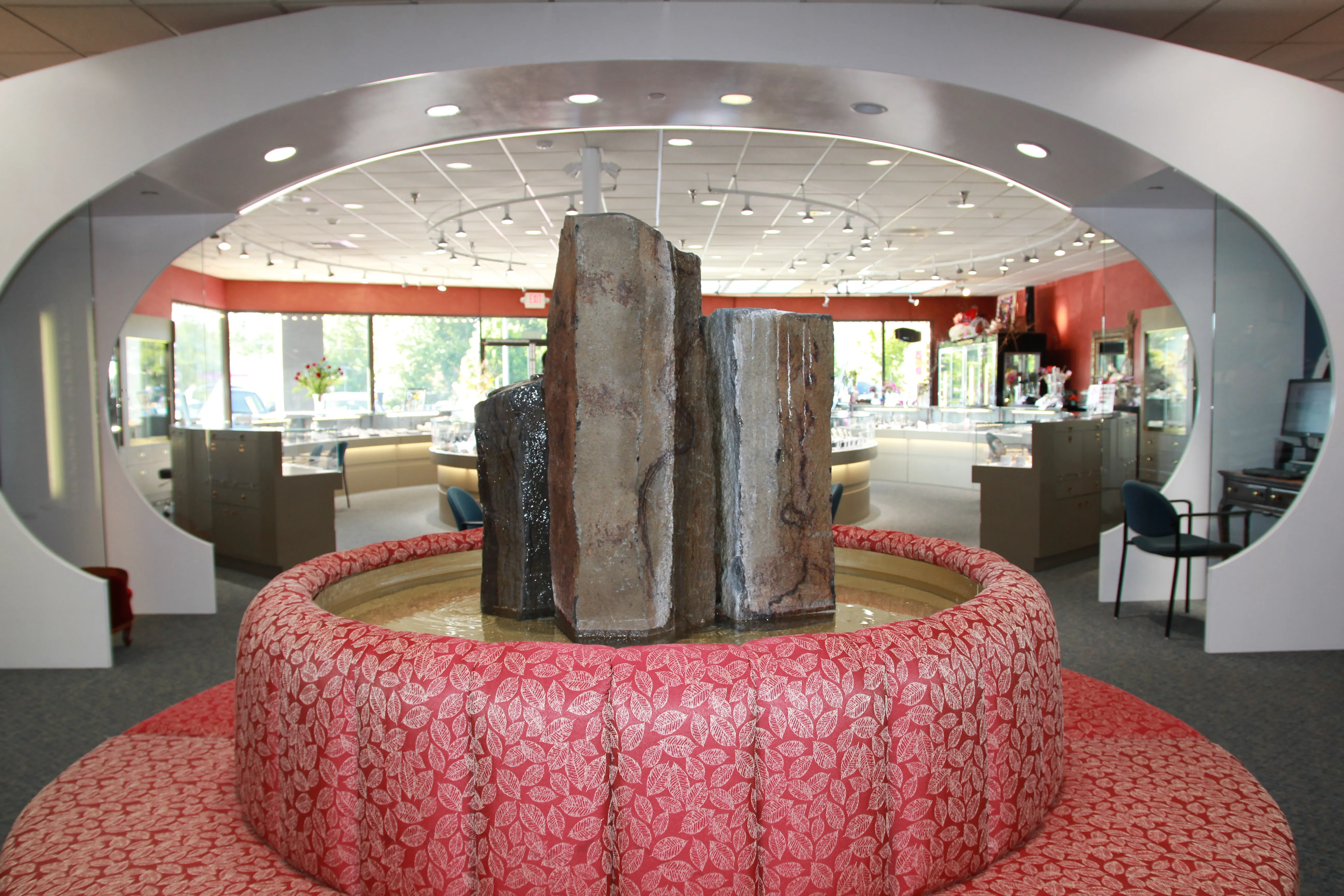 Interior view of Chipper's Jewelry featuring a decorative fountain and seating area, showcasing fine jewelry displays.