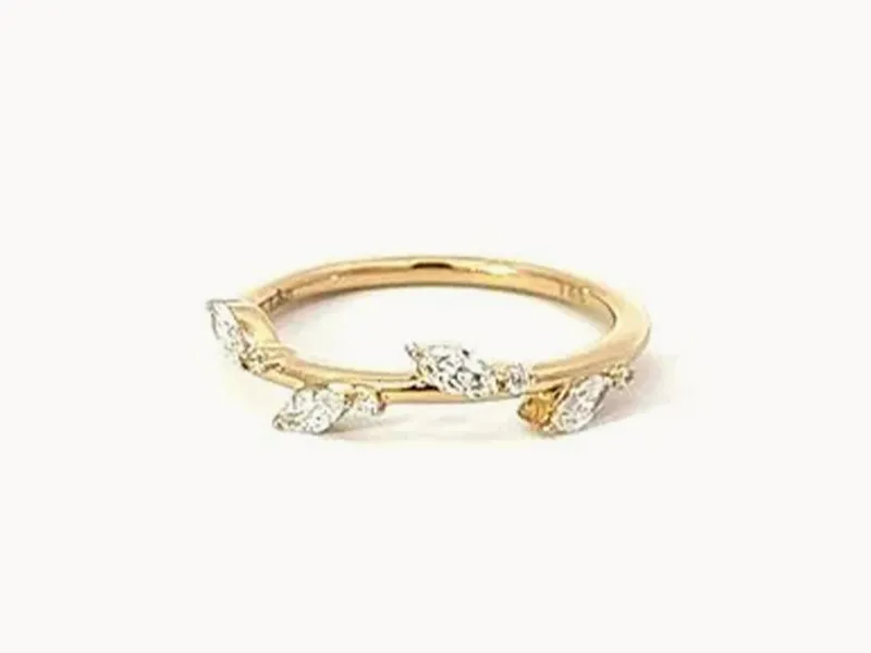 Gold ring with marquise diamonds set along the band.