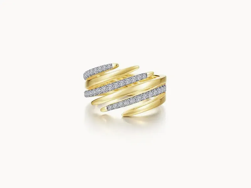 A gold spiral ring with diamond accents on a white background.