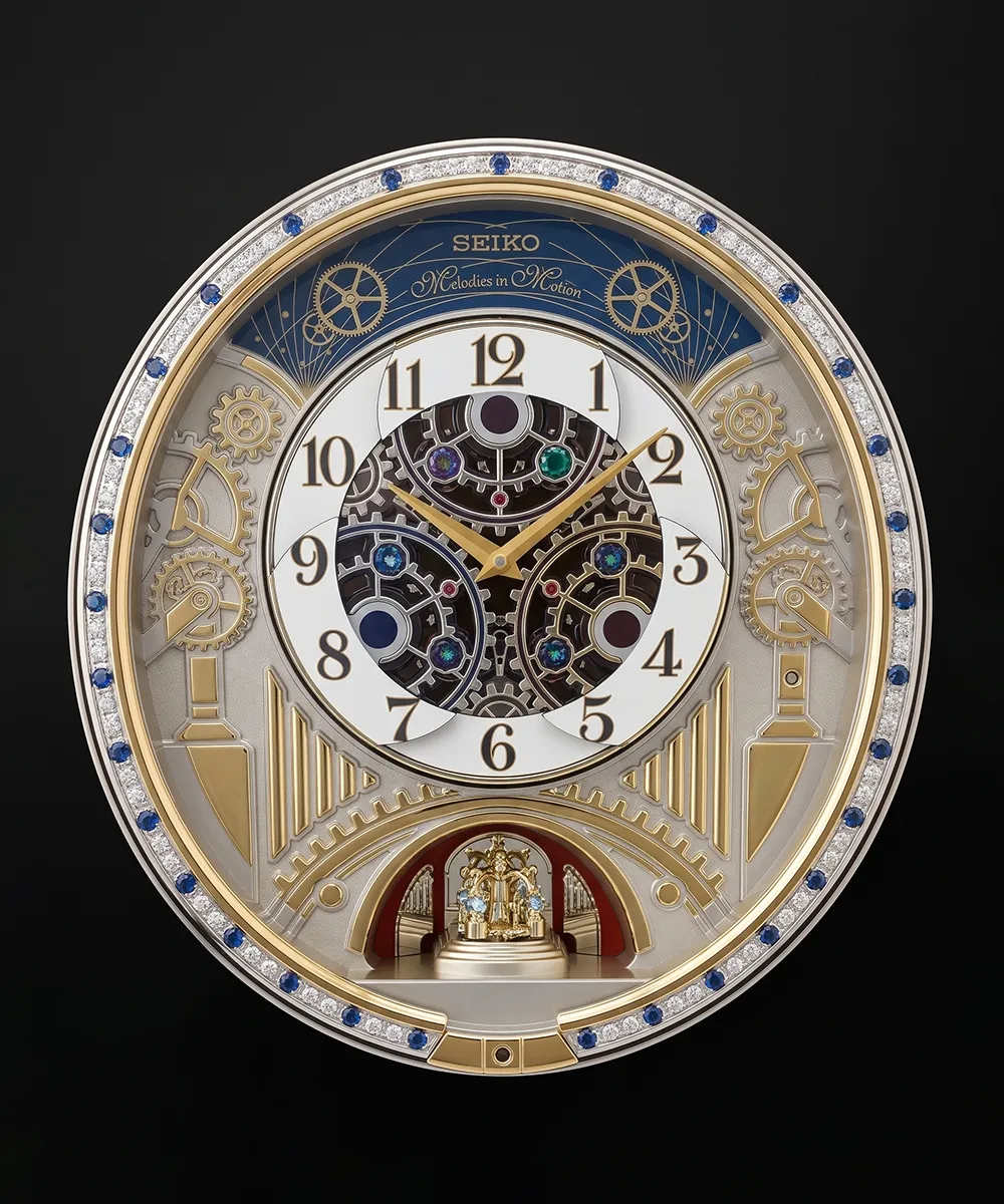 Intricate Seiko wall clock with gears, jewels, and gold accents on a black background.