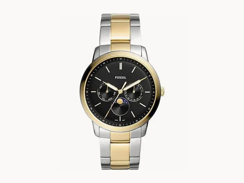 A two-tone Fossil watch with a black dial and gold accents on a metal bracelet.
