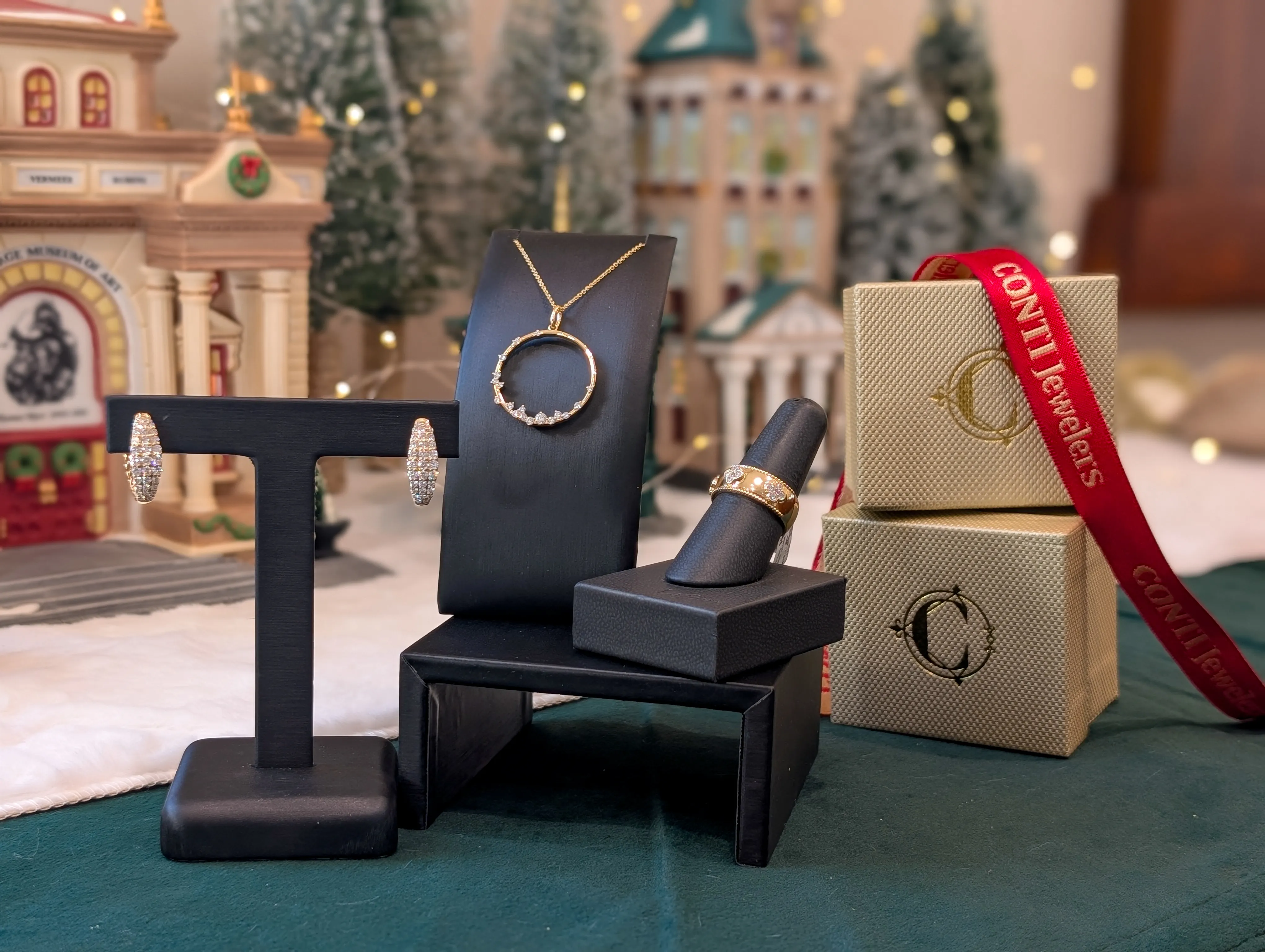 Display of elegant jewelry including necklaces, rings, and bracelets at Conti Jewelers, perfect for holiday gifting. Explore now