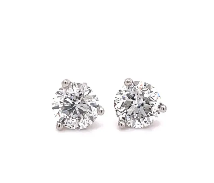 Sparkling diamond stud earrings displayed on a white background.