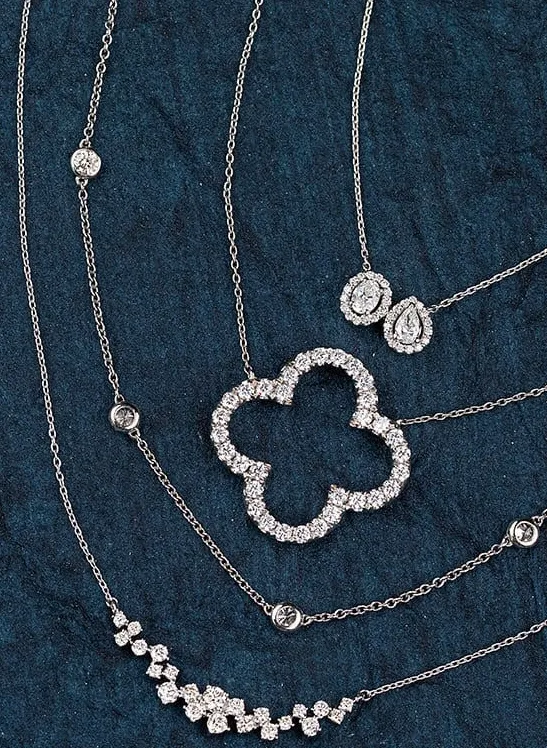 Ostbye rings with red stones on a gold background; click to explore more Ostbye designs at Dahlkemper's Jewelry Connection.