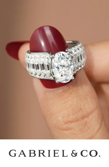 Elegant oval engagement ring with diamond accents by Gabriel & Co. Visit Dahlkemper's Jewelry Connection for more details.