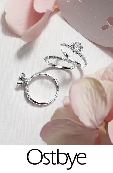 Elegant Ostbye bridal rings featuring diamonds and gold. Click to explore more at Dahlkemper's Jewelry Connection in Erie!