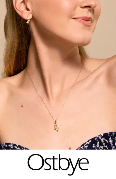 Model showcasing Ostbye jewelry, featuring gold earrings and a pendant necklace. Click to explore more Ostbye designs.