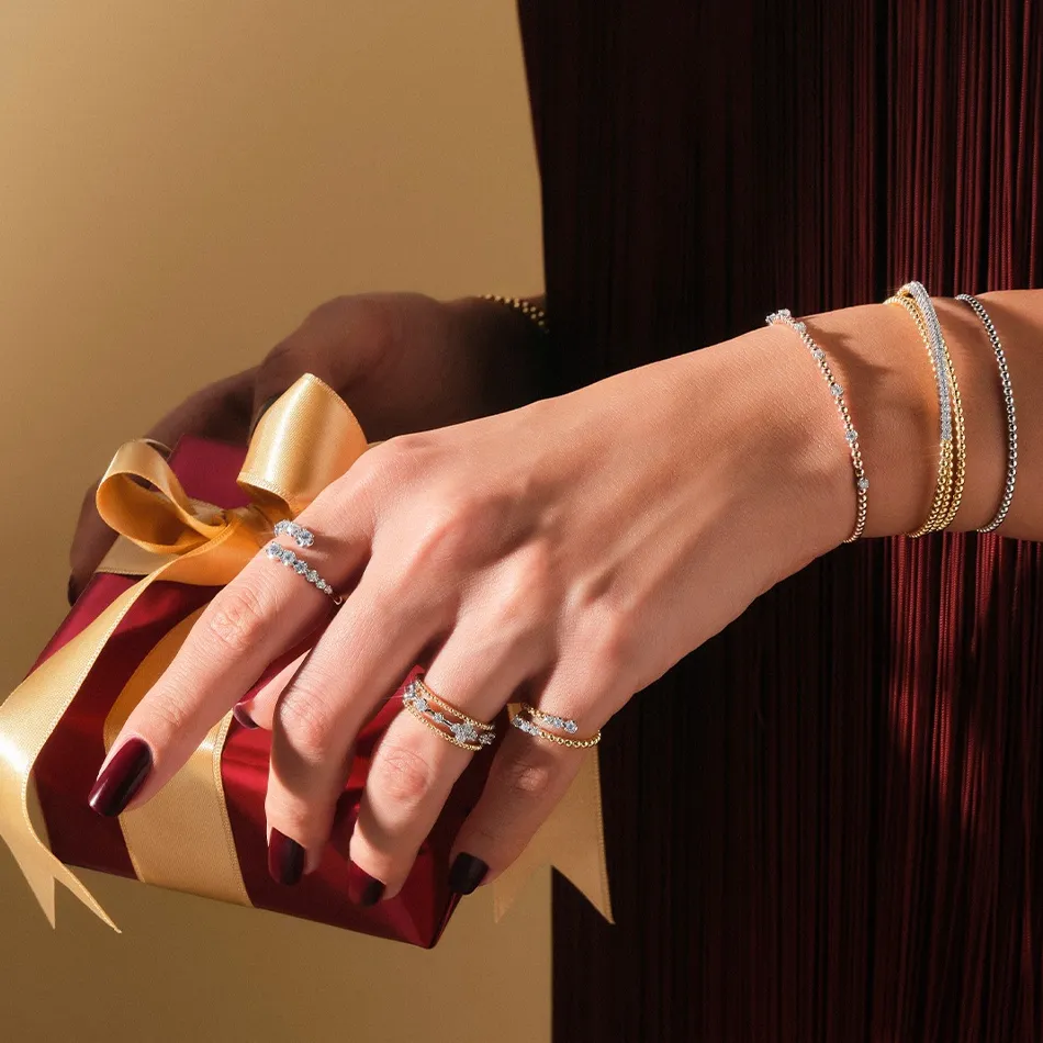 Model showcasing elegant jewelry while holding a gift box, promoting Dahlkemper's Jewelry Connection in Erie, PA.