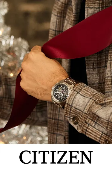 Man wearing a Citizen watch while holding a red ribbon. Click to explore more at Dahlkemper's Jewelry Connection.