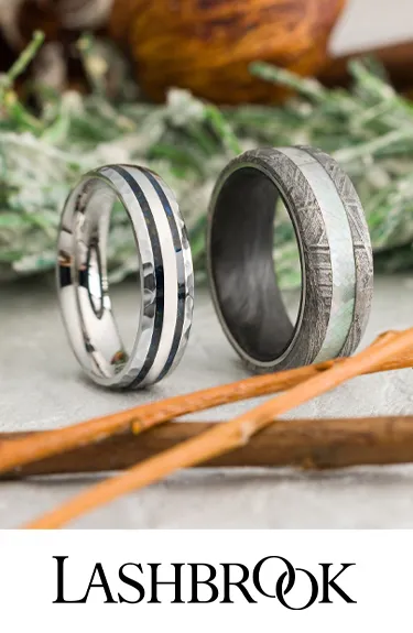 Two stylish wedding bands by Lashbrook, one with black texture and the other with a silver inlay. Click to explore more.