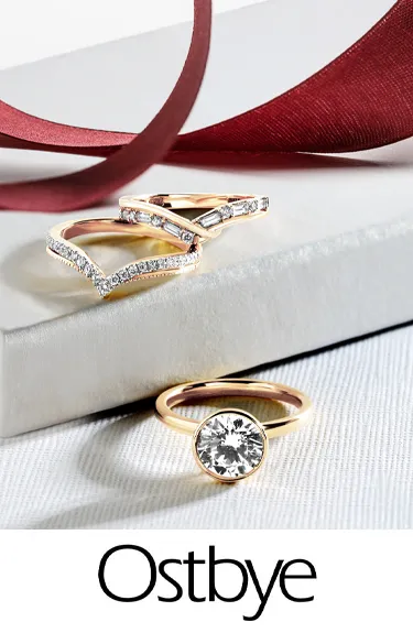 Elegant Ostbye bridal rings featuring diamonds and gold. Click to explore more at Dahlkemper's Jewelry Connection in Erie!