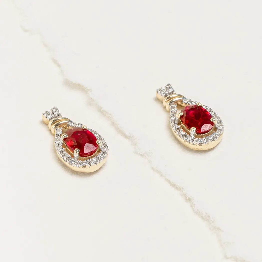 Elegant gold earrings featuring red gemstones surrounded by sparkling diamonds.