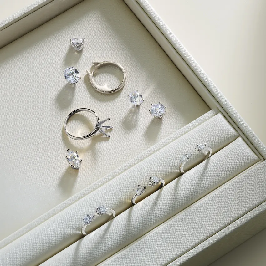 Elegant display of diamond engagement rings and earrings in a jewelry box.