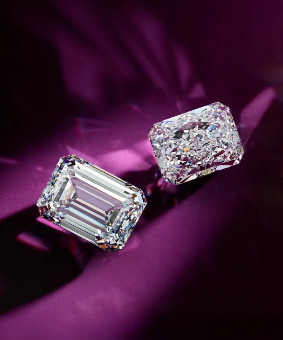 Two sparkling diamonds on a purple background, showcasing their brilliance and clarity.