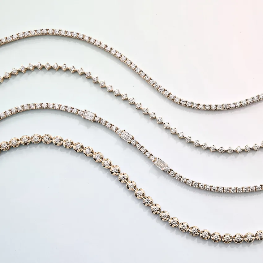 Four elegant diamond tennis bracelets in varying styles displayed on a light background.