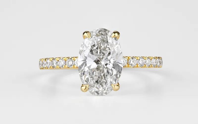 Elegant oval diamond ring with a gold band and smaller diamonds.