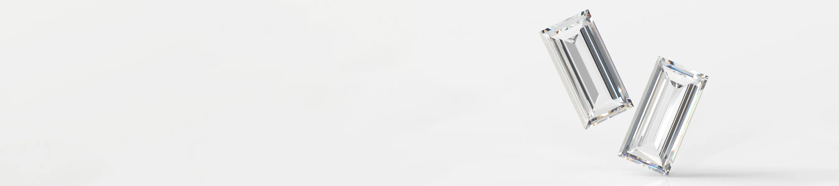 Two sparkling rectangular diamonds on a white background.