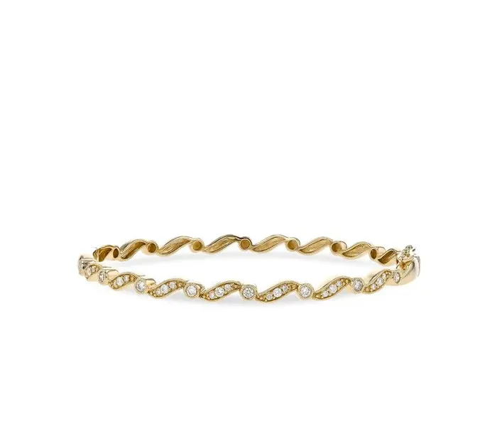 Gold wave bracelet with sparkling stones, perfect for gifting.