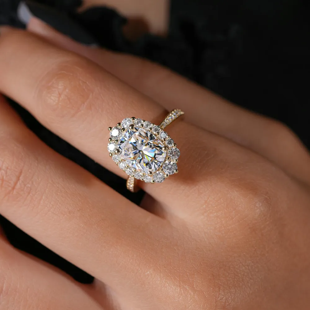 Stunning cushion-cut diamond ring with halo setting on a hand, showcasing elegance and luxury.