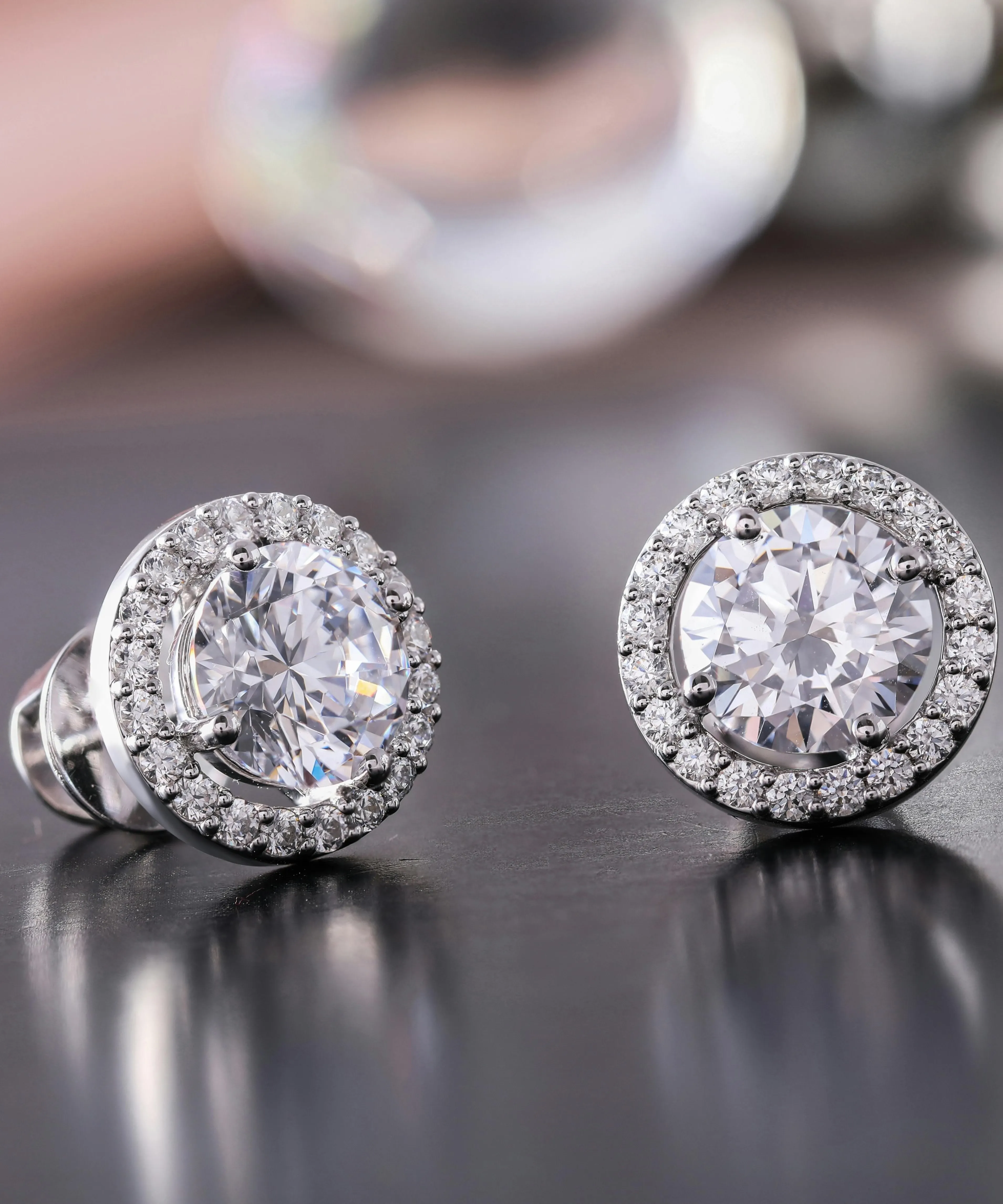 Close-up of a woman's ear with a sparkling diamond stud earring. 