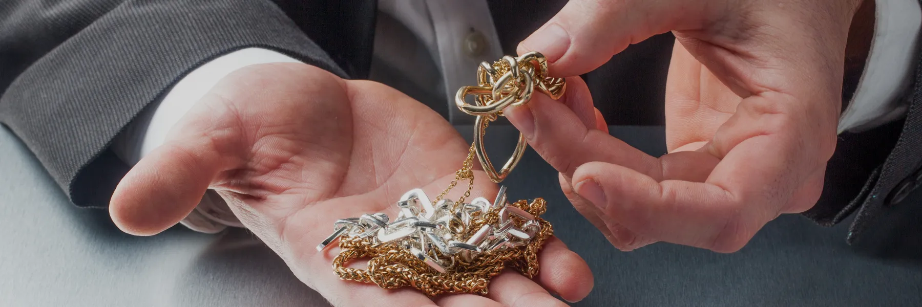 hands holding gold fashion jewelry